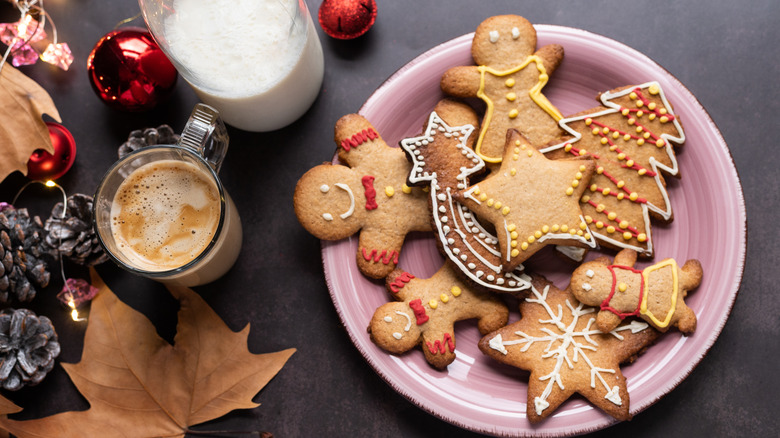 dish of iced gingerbread cookies with coffee, milk, and seasonal items