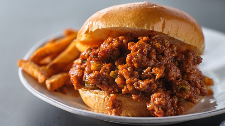 Sloppy joe sandwich on plate with french fries