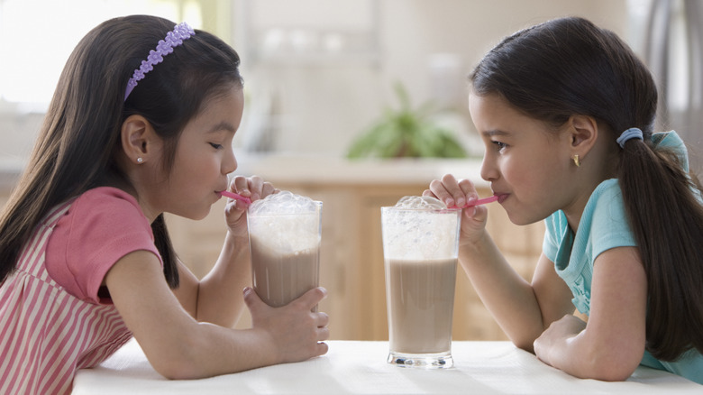 Two kids drinking coffee milk