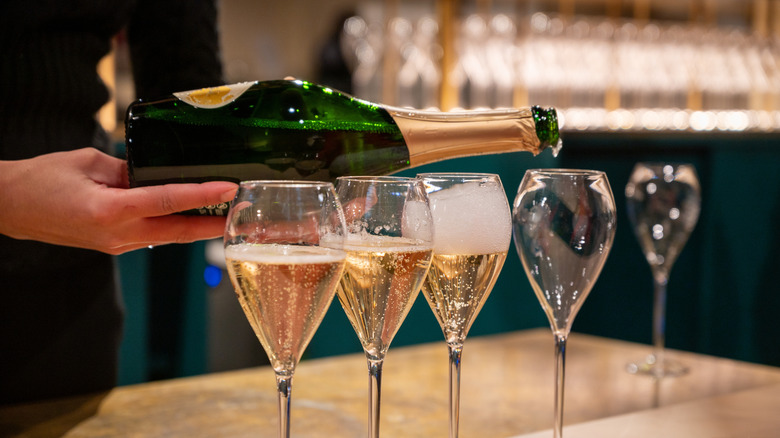 Pouring sparkling wine as part of a tasting.