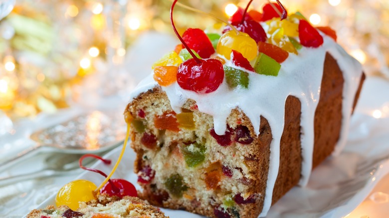 Fruitcake with icing and cherries on top