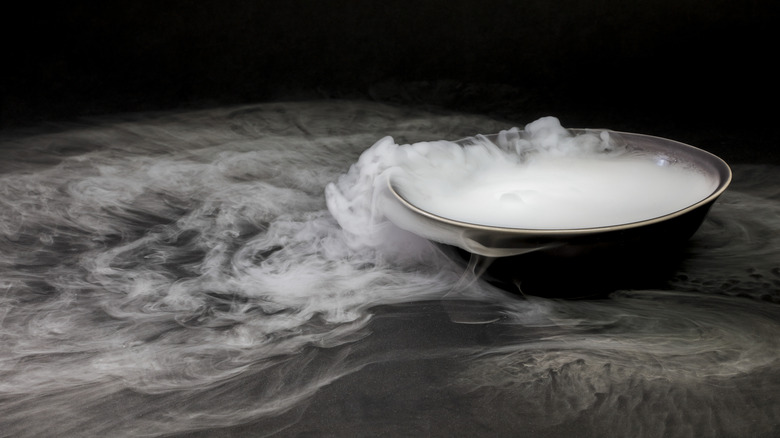 A bowl of dry ice with fog spilling over the edge