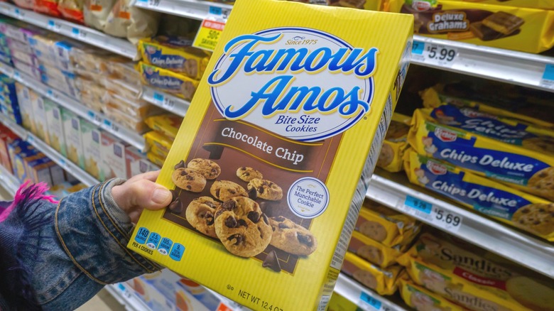 Hand holding box of Famous Amos cookies