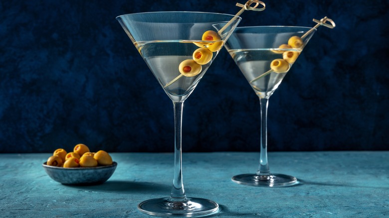 Two martinis with olive garnishes