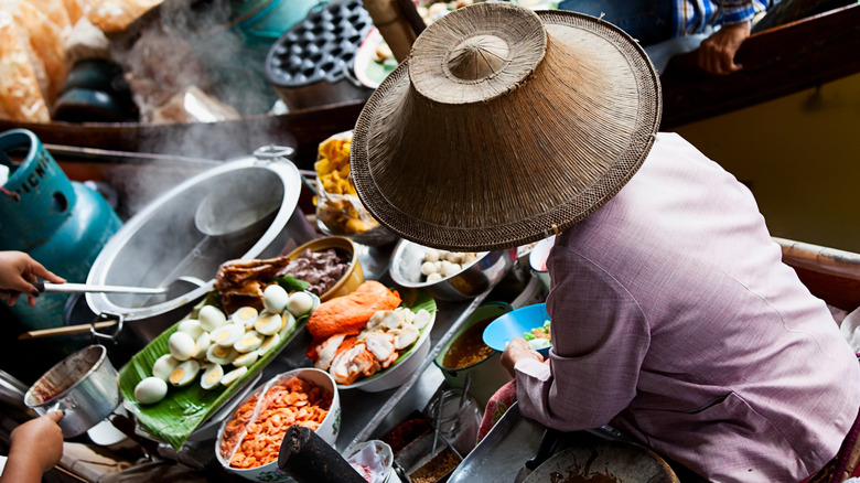 Woman serving authentic Thai food
