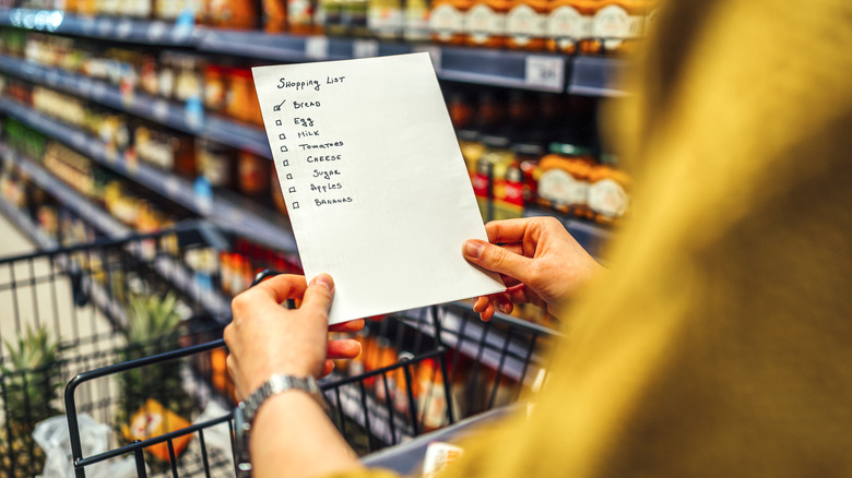 A shopper reads their shopping list
