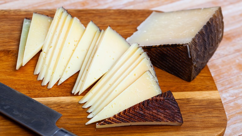 Slices of Iberico cheese on cutting board