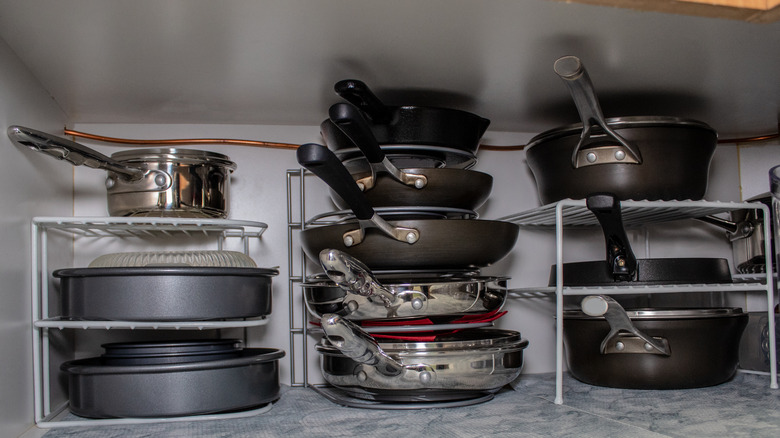 pans stacked in cupboard
