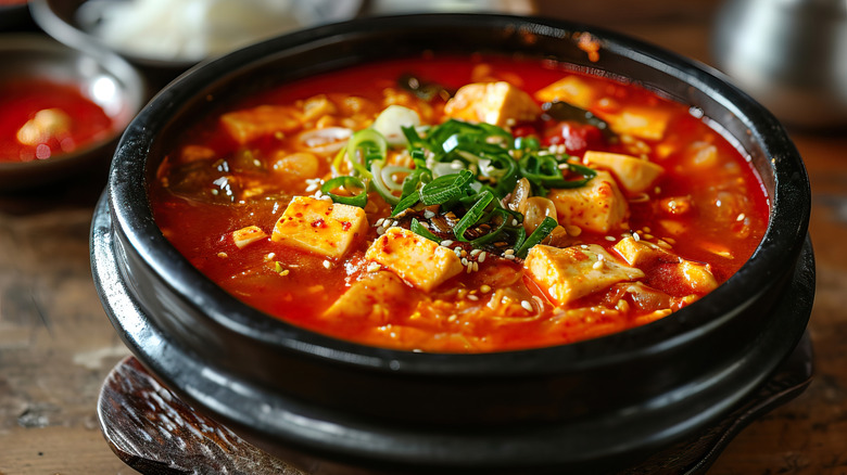 Korean soft tofu soondubu jjigae soup in traditional hot pot