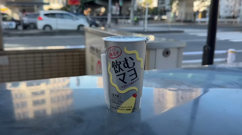 A cup of drinkable mayonnaise from Lawson's in Japan sits on a glossy table