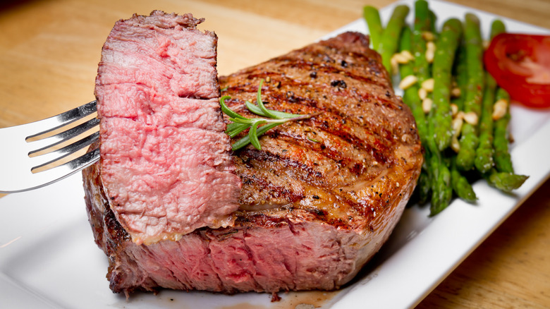 grilled steak cooked medium rare on a plate