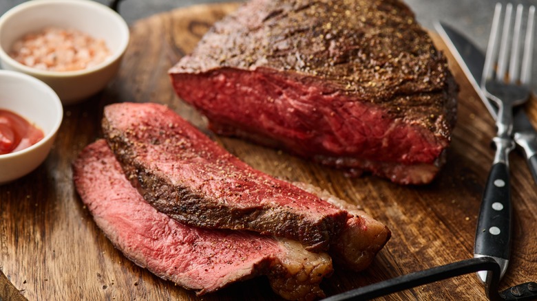 Grilled steak sliced on cutting board