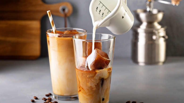 Creamer being poured into iced coffee