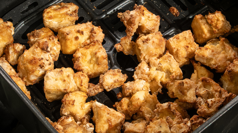 tofu bites in an air fryer basket