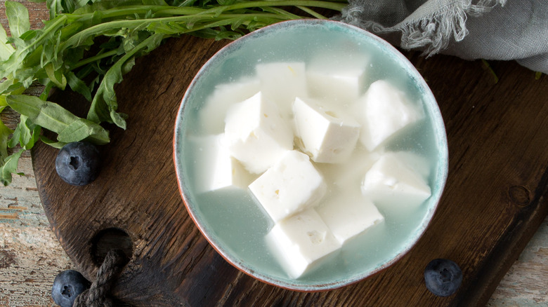 Bowl of cubed feta cheese in brine