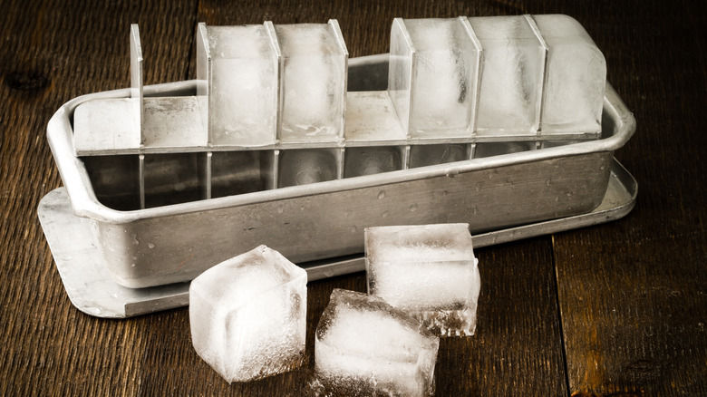 Old fashioned metal ice tray with frozen ice cubes
