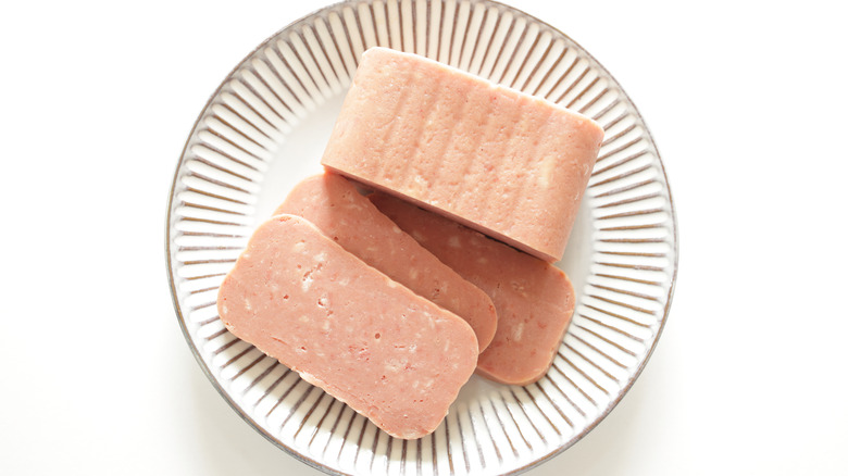 sliced spam sitting on ceramic plate