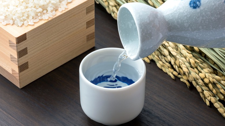 pouring sake into a small cup