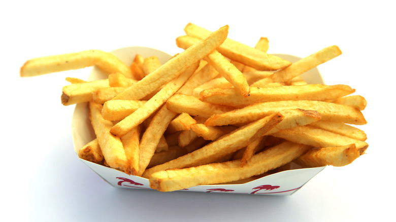 Closeup of a container of In-N-Out french fries against a white background