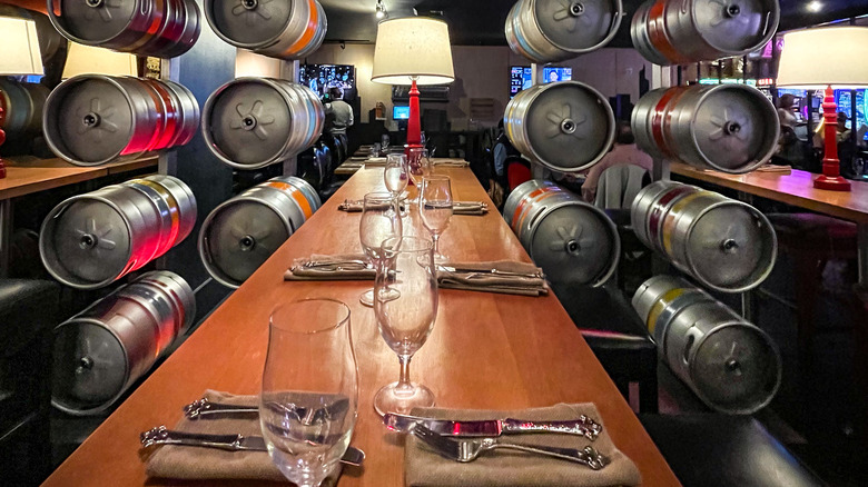 Table at Gordon Ramsay Bar & Grill with kegs used as decor