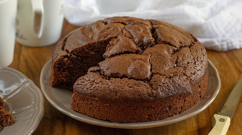 Moist unfrosted chocolate cake with wedge cut out