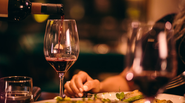 Waiter pouring a glass of wine