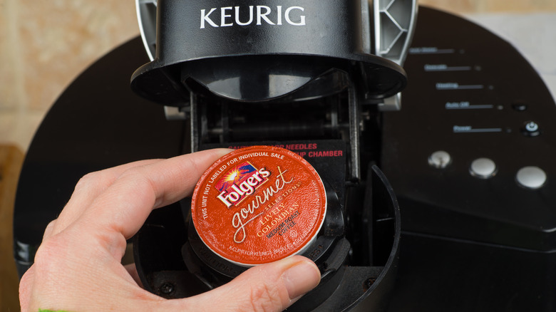 Person putting a pod inside a Keurig