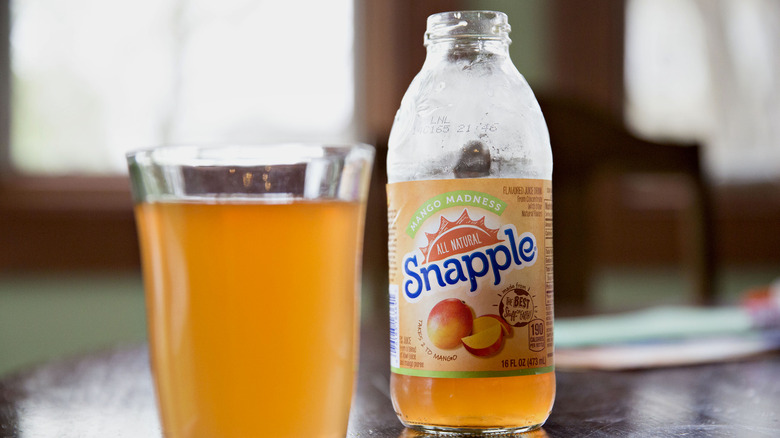 Bottle of snapple with glass of juice