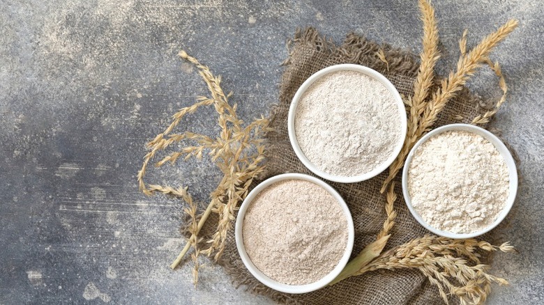 flour in white bowls with whole grains