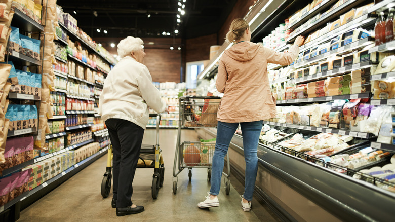 Elderly woman shopping with younger woman