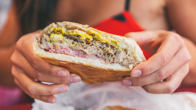 Holding a pressed Cuban sandwich