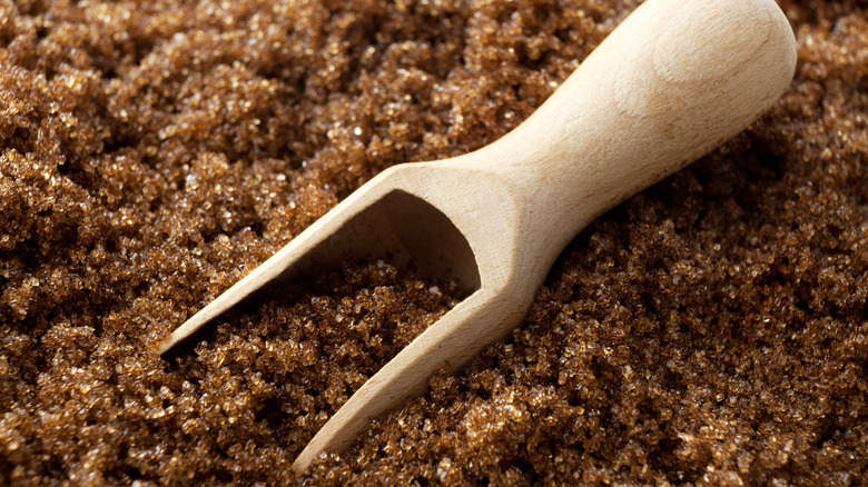 moist brown sugar with wooden scoop