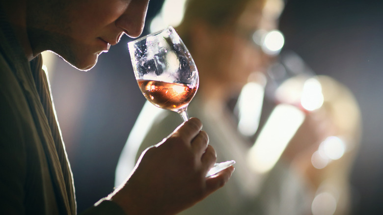 Person sniffing wine in a glass