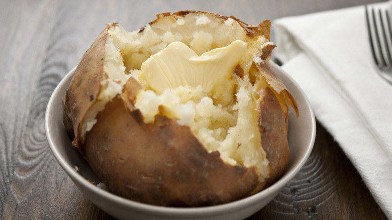 A baked potato with melting butter