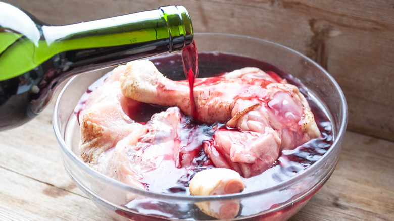 bowl of chicken marinating in red wine