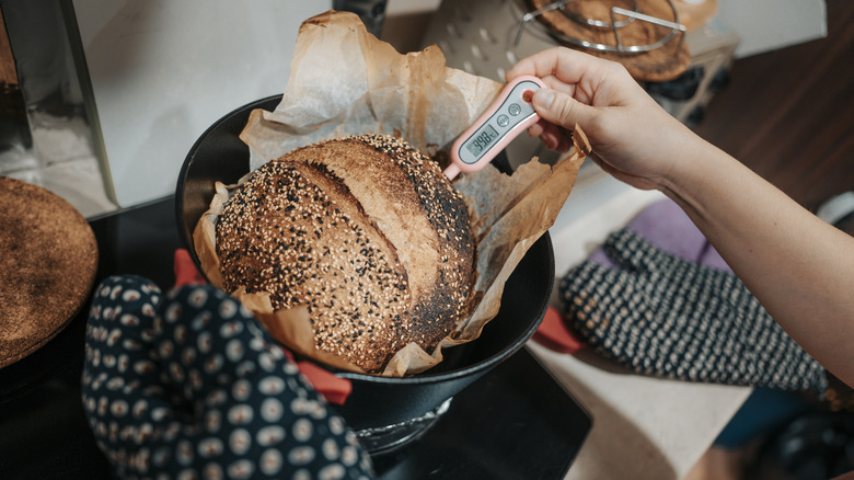 Food thermometer testing bread loaf