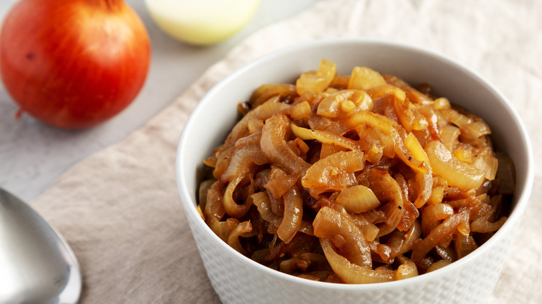 caramelized onions in a bowl with fresh onions