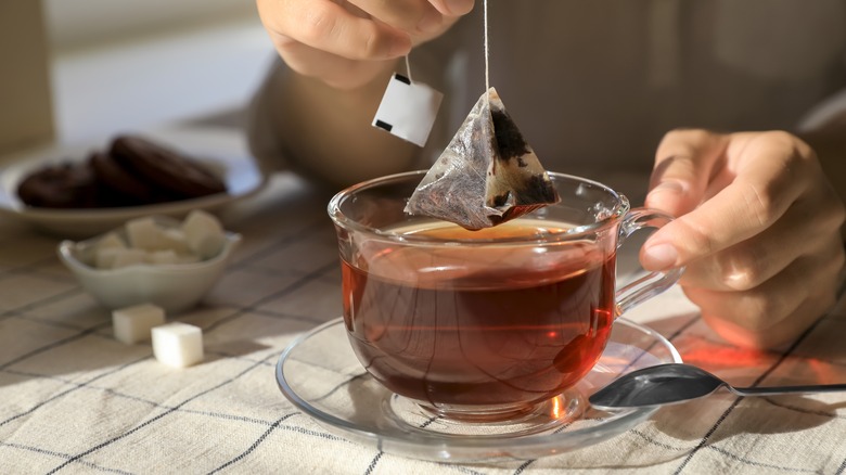 Person brewing a cup of tea