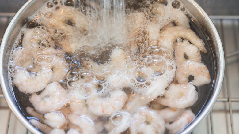 defrosting shrimp in bowl of water