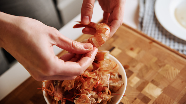 woman peeling shrimp