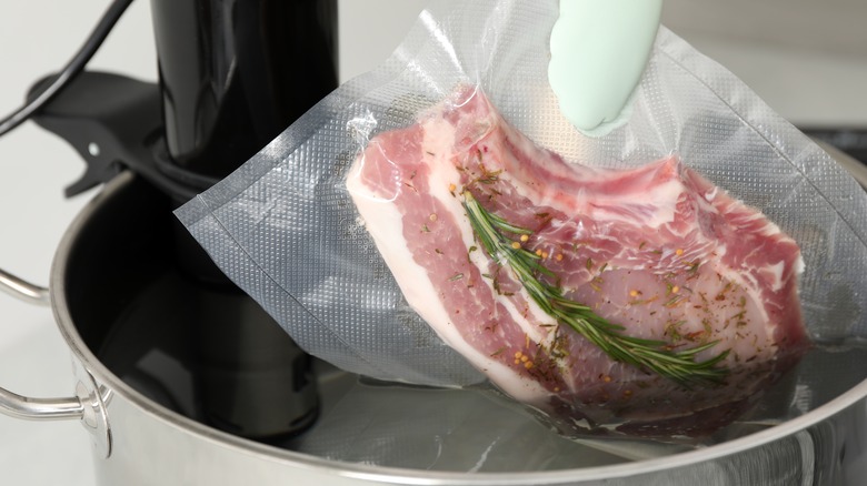 Putting pork chop in sous vide cooker