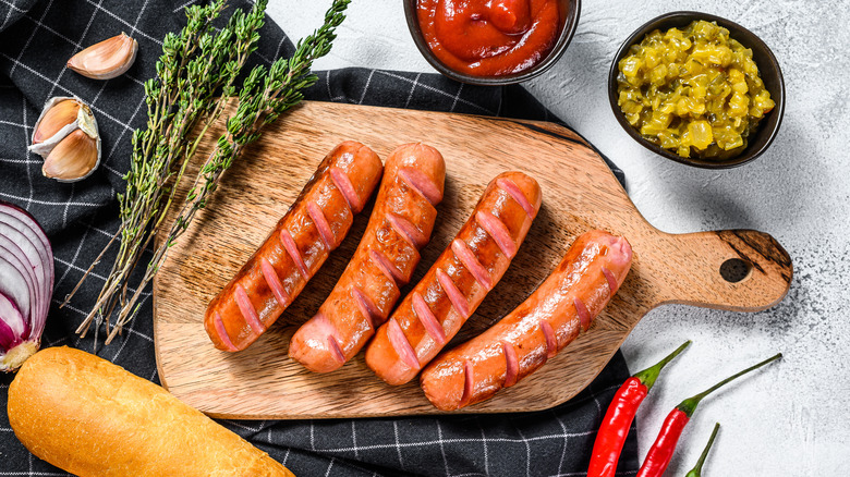 homemade hot dogs on wooden cutting board