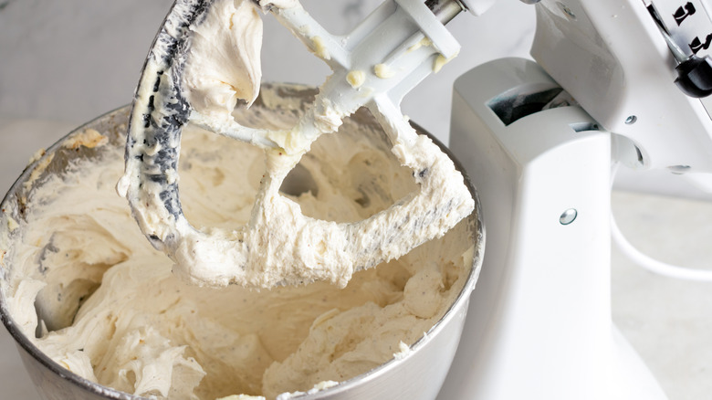 A stand mixer mixing buttercream frosting