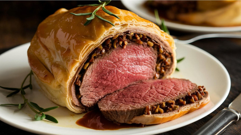 Sliced beef Wellington on a white plate