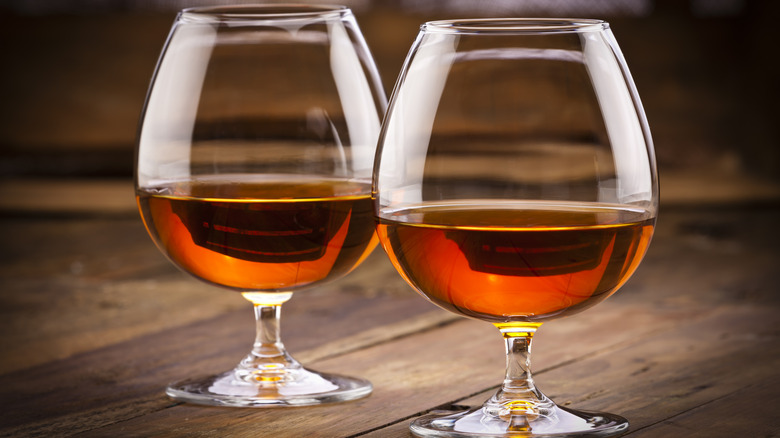 Cognac in two snifter glasses on a wooden table