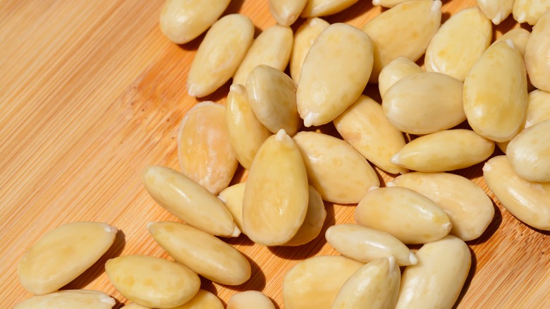 blanched almonds on a wooden counter top