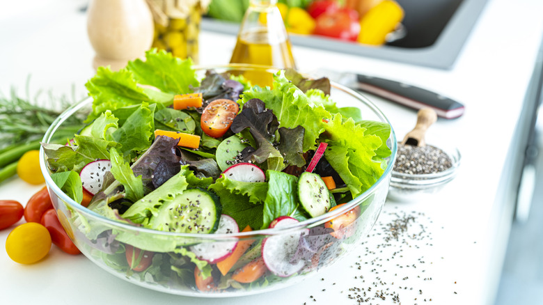 chia seeds sprinkled over bowl of salad