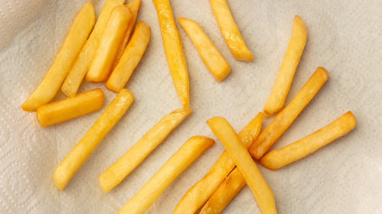 French fries sitting to dry on a paper towel