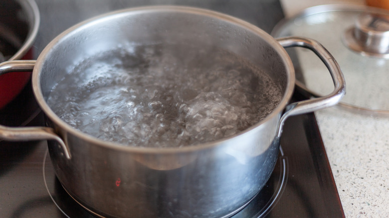 A large steel pot with boiling water