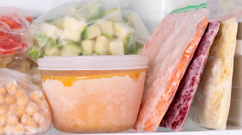 frozen food in various containers in freezer